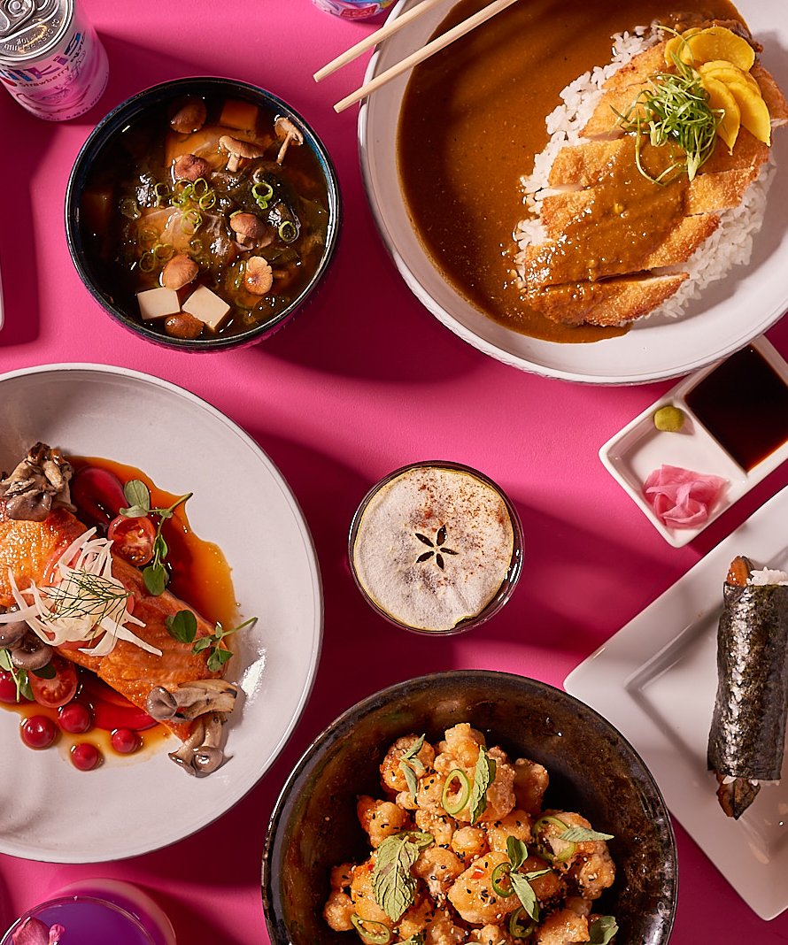 A table of Under Wraps dishes: katsu curry, glazed salmon, hand rolls and miso soup